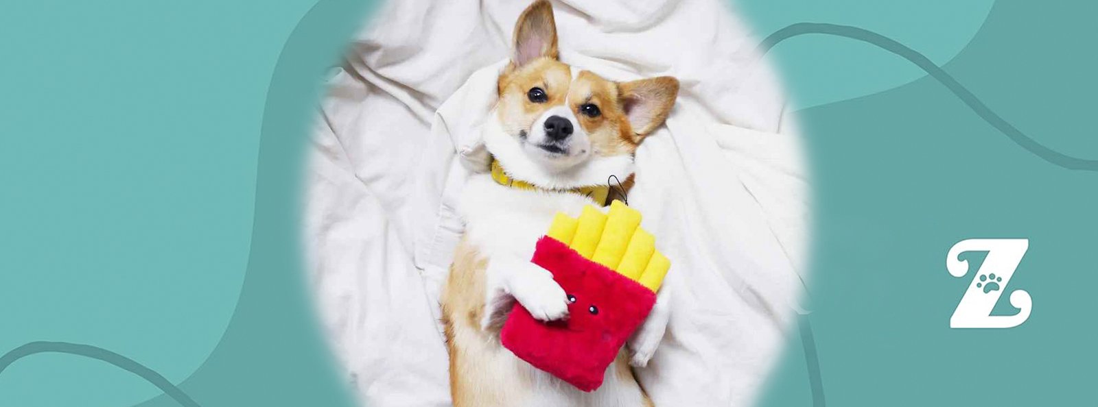 A cheerful Corgi dog lying on a soft white blanket, clutching a red plush toy shaped like French fries, symbolizing the precious gifts we hold dear.