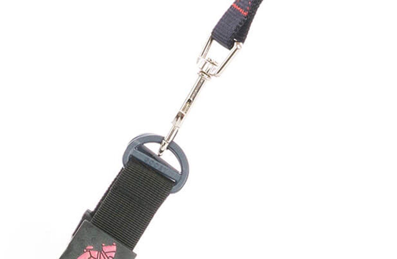 Close-up of a leash clip mechanism with a POM plastic ring attached to a fabric strap, highlighting its durability and lightweight design.