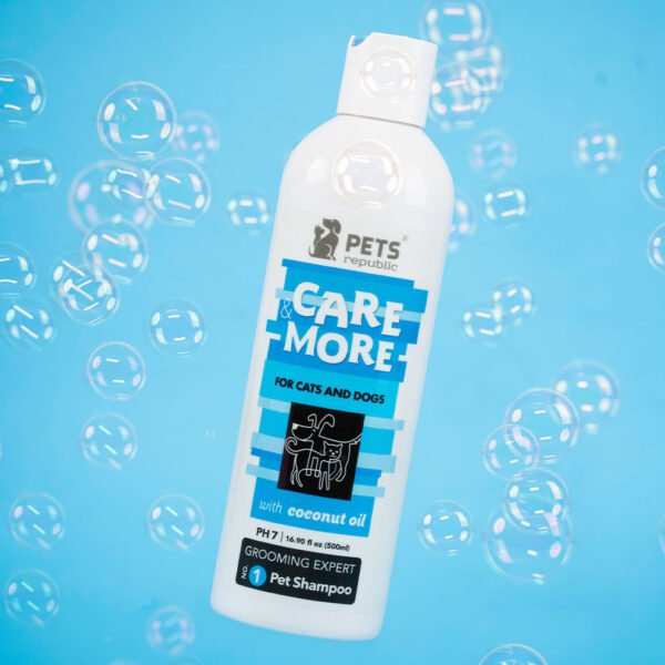 Image of a white bottle with blue and black labeling of Pets Republic Care & More Shampoo, enriched with coconut oil, specifically formulated for cats and dogs, size 500ml. The bottle is surrounded by floating bubbles against a light blue background.