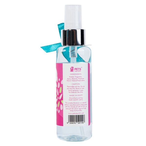 Backside of Pets Republic Perfume 125ml bottle with pink label and turquoise bow, showing product information and paw print design