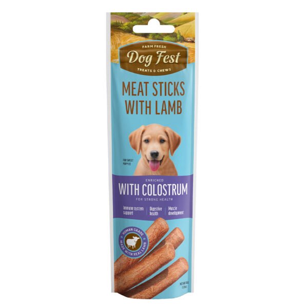 Packaging of Dog Fest Meat Sticks with Lamb for puppies, featuring a blue and white color scheme, an image of a puppy, and a ‘With Colostrum’ badge.