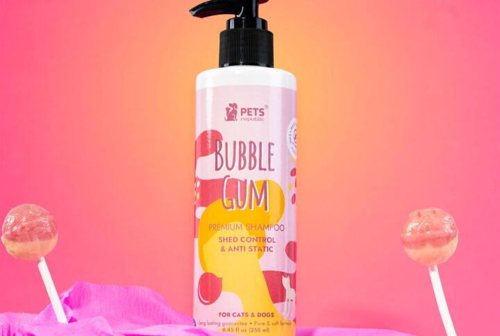 Pets Republic’s 250ml bottle of Shed Control & Anti-Static Tearless Shampoo with a bubble gum scent, displayed against a pink background with lollipop decorations