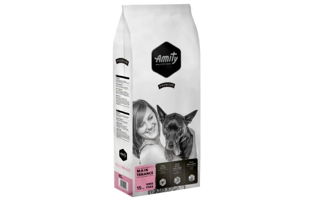 A bag of Amity Premium Dog Dry Food Maintenance with 'Amity QUALITY PET FOOD' and a graphic of a happy woman with a dog on the front. This image highlights the simple, effective ingredients like dehydrated chicken protein, poultry fat, and beet pulp that ensure reliable daily nutrition and digestive ease for adult dogs.
