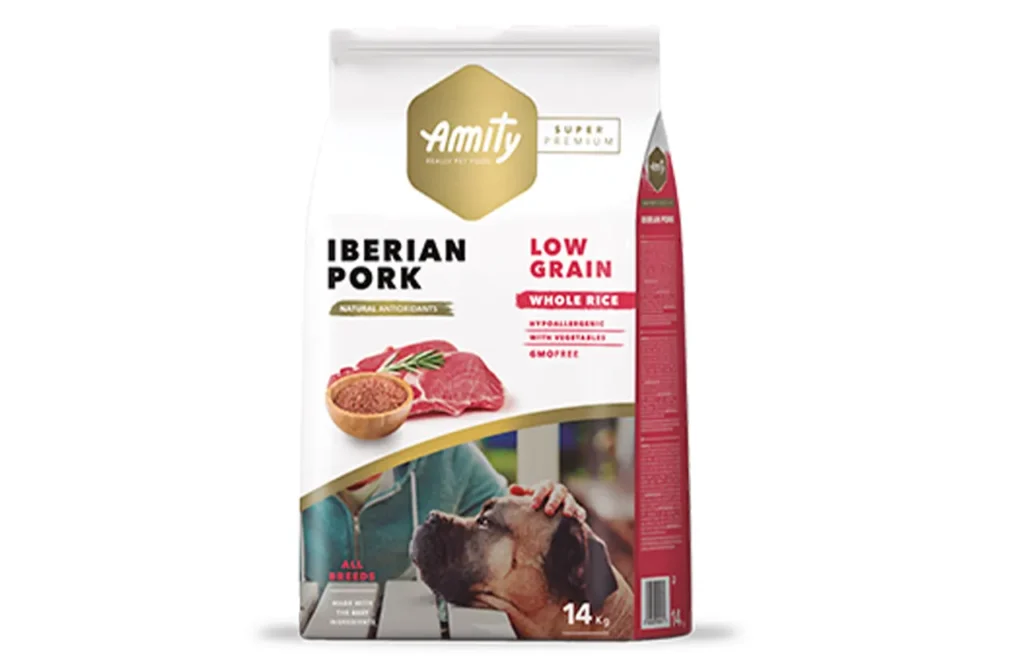 A bag of Amity Super Premium Low Grain Iberian Pork dog food, showcasing the product name and a picture of raw pork, representing the carefully selected ingredients for digestive comfort, joint mobility, and sustained energy, such as dehydrated Iberian pork protein, whole rice, and Omega-3 & Omega-6.
