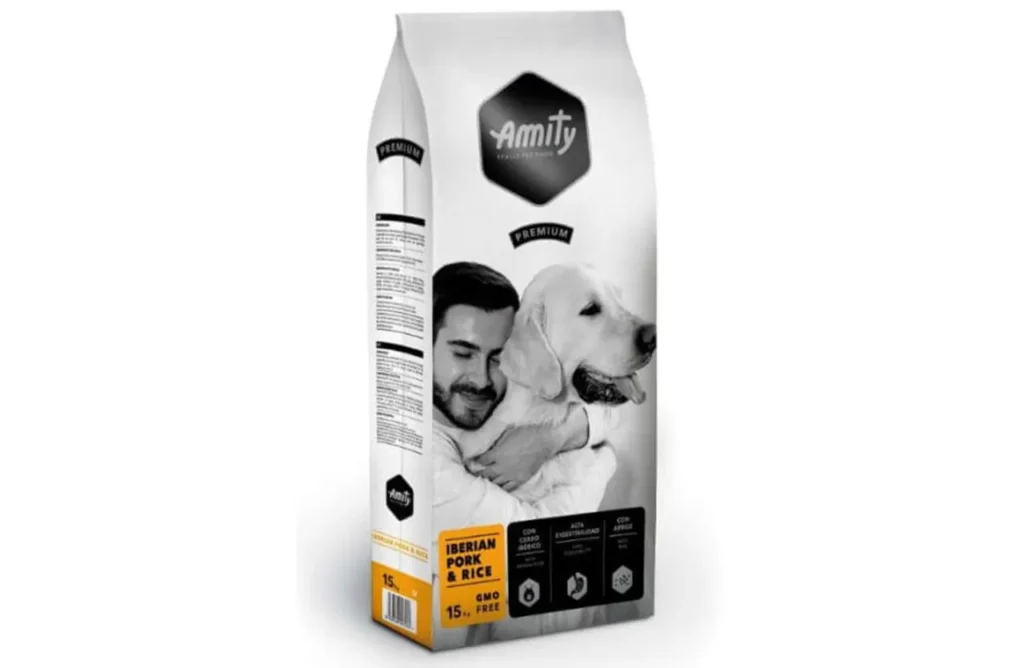 A white and black bag of Amity Premium Dog Dry Food, featuring a man hugging a Golden Retriever and highlighting "Iberian Pork & Rice" and "15 kg," representing the wholesome ingredients for gentle digestion and lasting energy provided by the product.