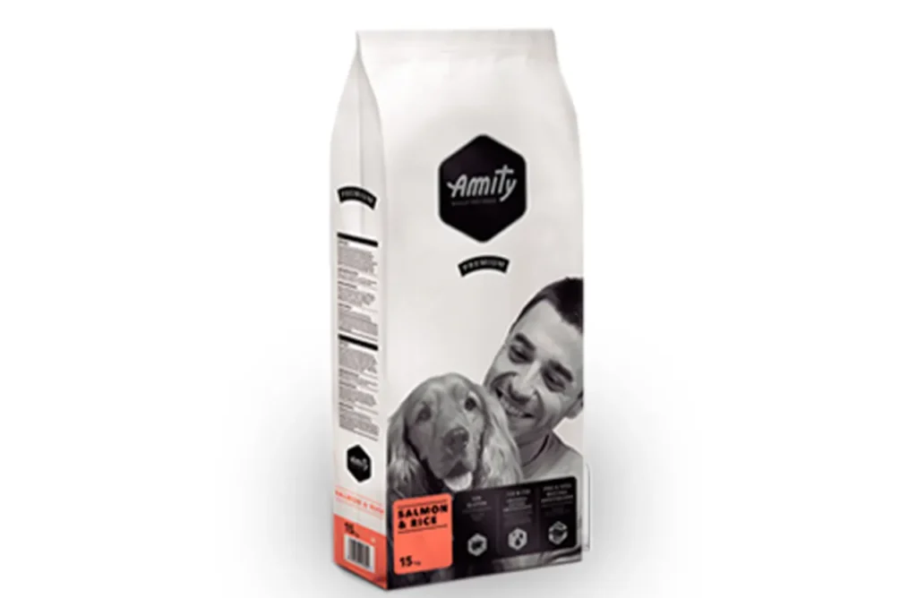 A bag of Amity Premium Dog Dry Food Salmon & Rice, showcasing the product name and a salmon graphic, representing the simple, clean ingredients like dehydrated salmon protein, rice, Omega-3 & Omega-6, and essential vitamins & minerals for easy digestion and optimal skin & coat health.
