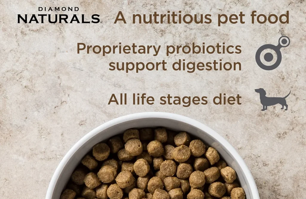 Close-up of Diamond Naturals kibble in a bowl with text highlighting "Proprietary probiotics support digestion" and "All life stages diet."