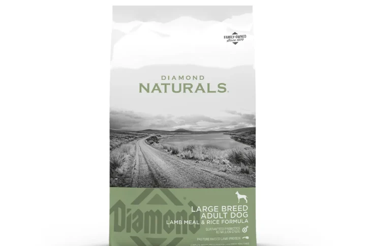 Studio shot of the Diamond Naturals Large Breed Adult Dog Lamb Meal & Rice Formula bag. The design features a white top section with a black-and-white rural landscape and a muted green bottom section with key nutritional claims, including "Pasture-Raised Lamb Protein" and "Glucosamine & Chondroitin for Joint Support."