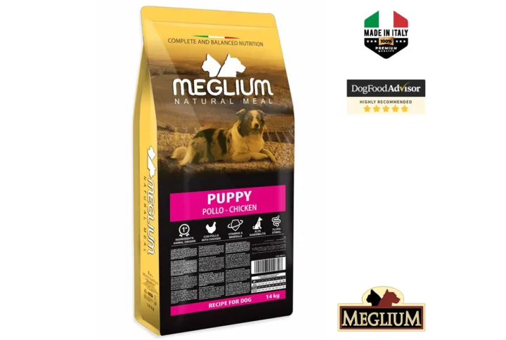 Studio shot of the Meglium Dog Puppy 14KG bag. The design features a clean layout with a white background, a dog silhouette, and key nutritional benefits.