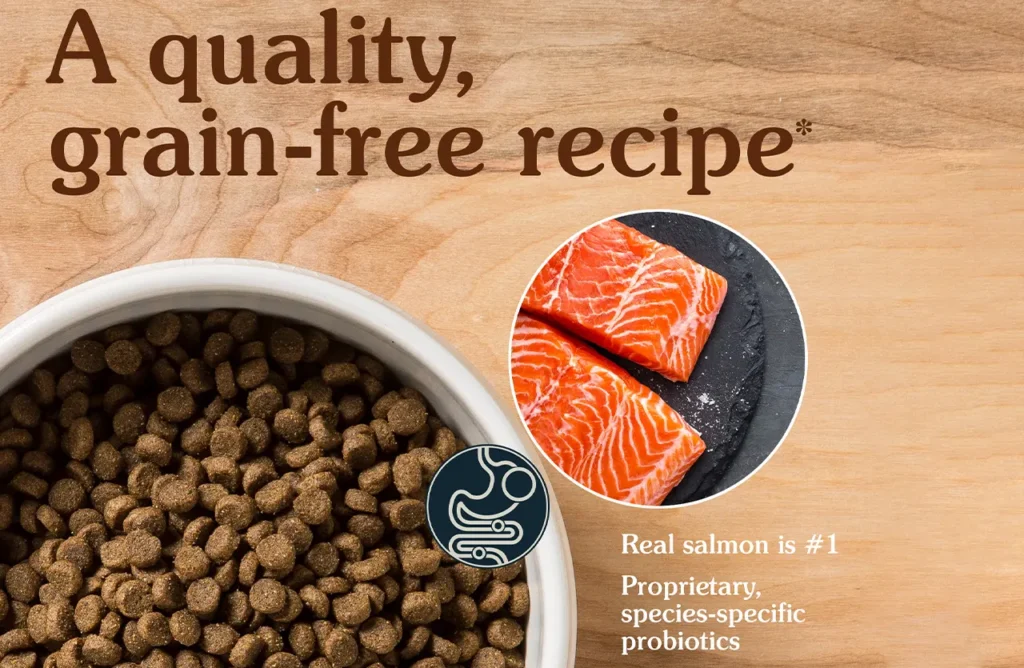 Close-up of Taste of the Wild Pacific Stream puppy kibble in a bowl next to fresh salmon fillets, highlighting the quality and representing the easy feeding aspect described in the "Enjoy Effortless Feeding Every Time" section.